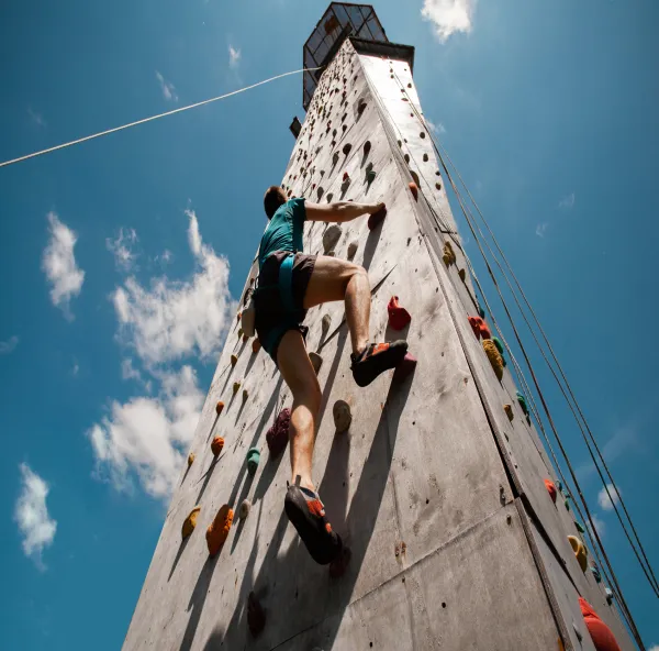Climber on the outdoor wall climbing tower