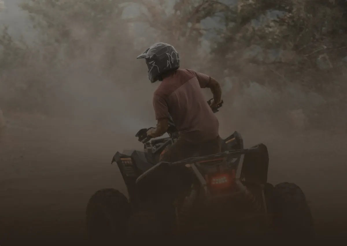 Rider on a quad bike kicking up dust