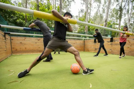 Team carrying a pole together in a team-building game
