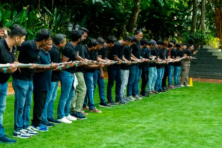 Team lined up holding a rope in a team-building activity