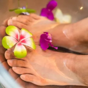 Pedicure with flowers placed between the toes