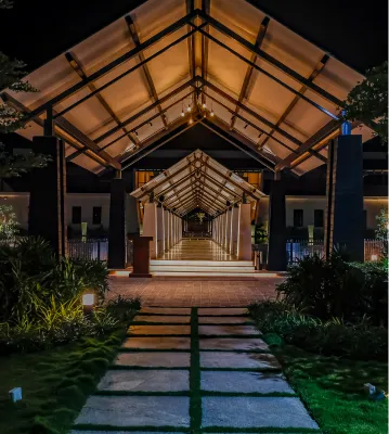 Lit walkway leading to the resort entrance at night