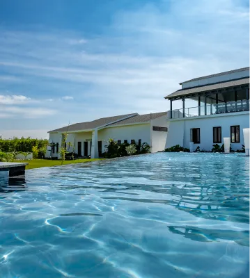 Infinity pool beside the white resort villas