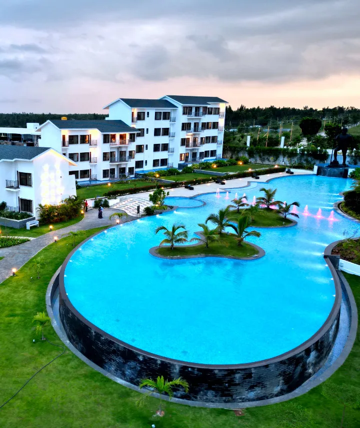Aerial view of the island pool and villas at Sportico Resorts