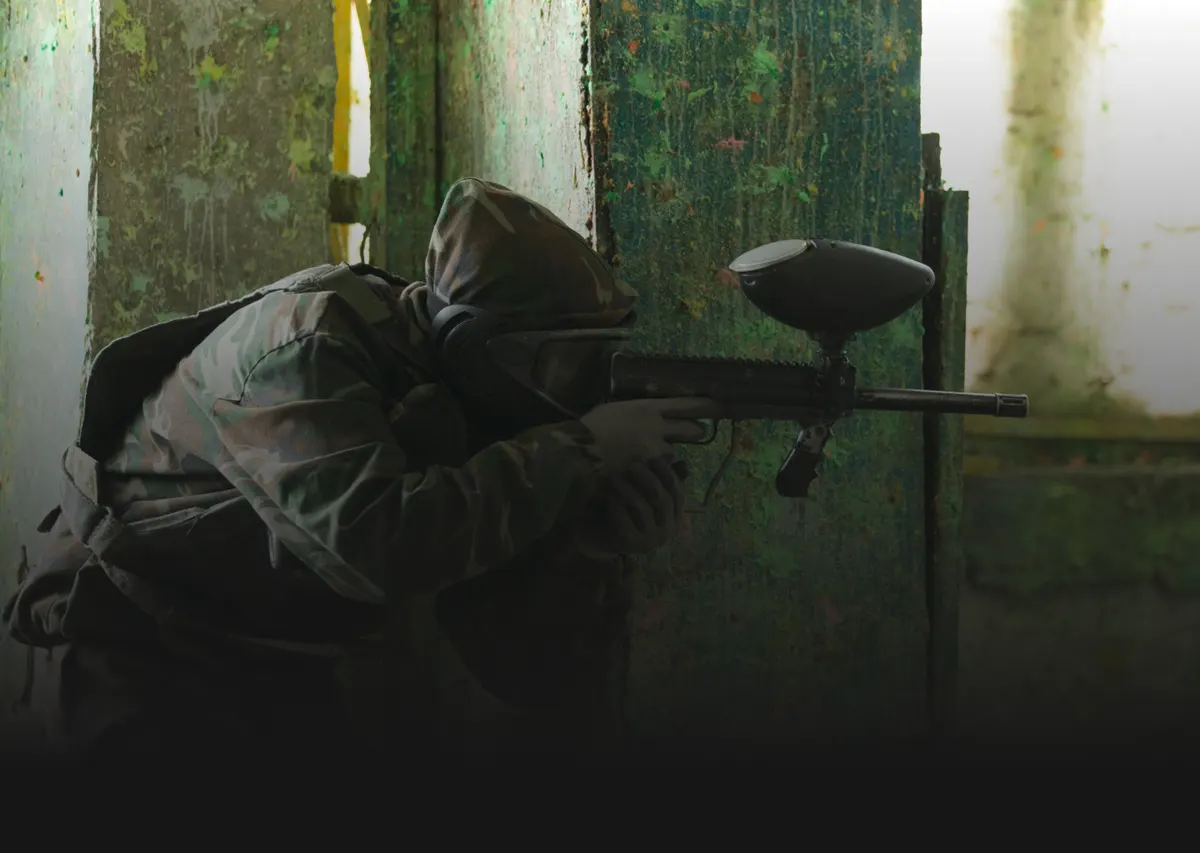Paintball player in camouflage on the field