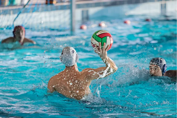 Players tossing a ball during pool volleyball