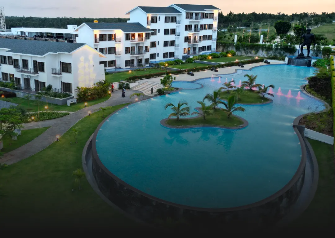Island pool surrounded by resort villas at Sportico Resorts