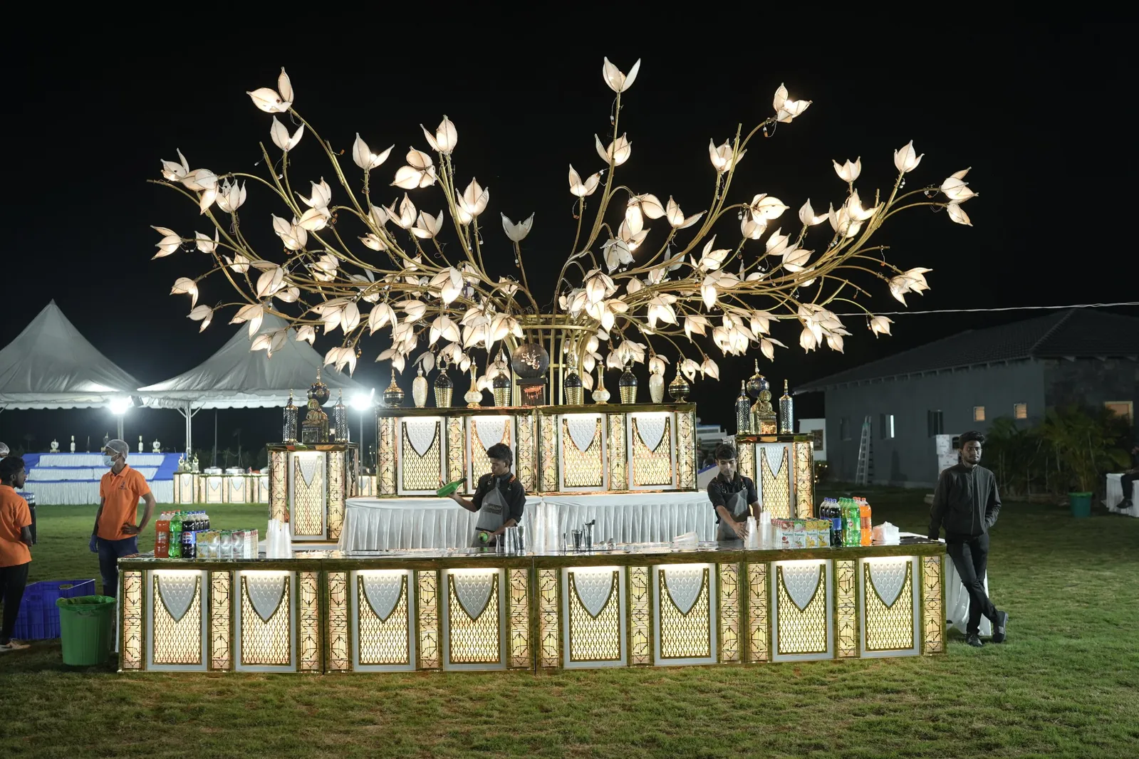 Bar counter with light décor on the lawn for the New Year party at Sportico Resorts