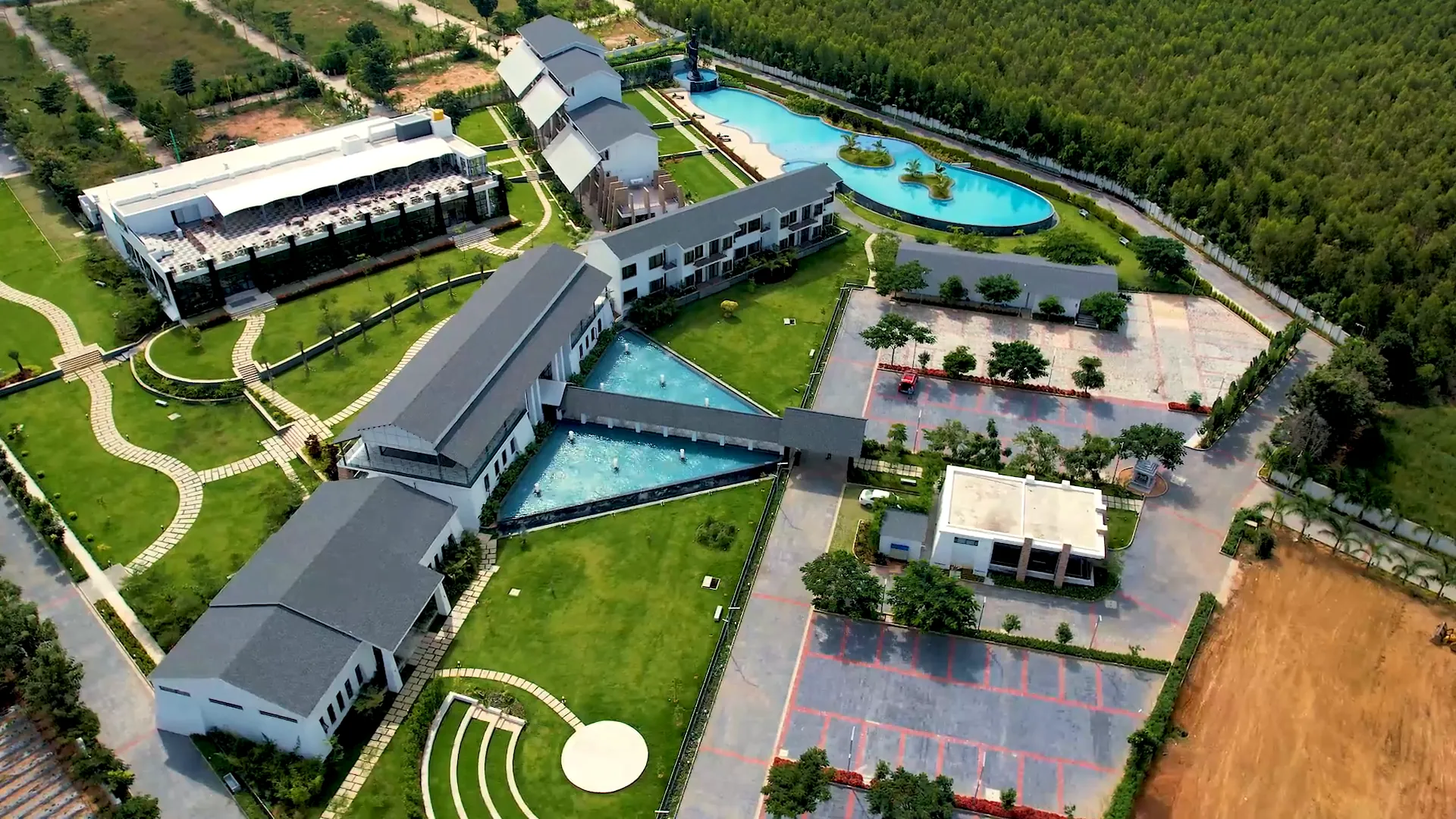 Aerial view of Sportico Resorts and its pools at dusk