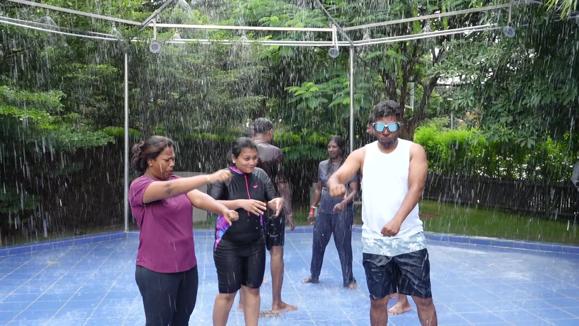 Corporate team enjoying the rain dance