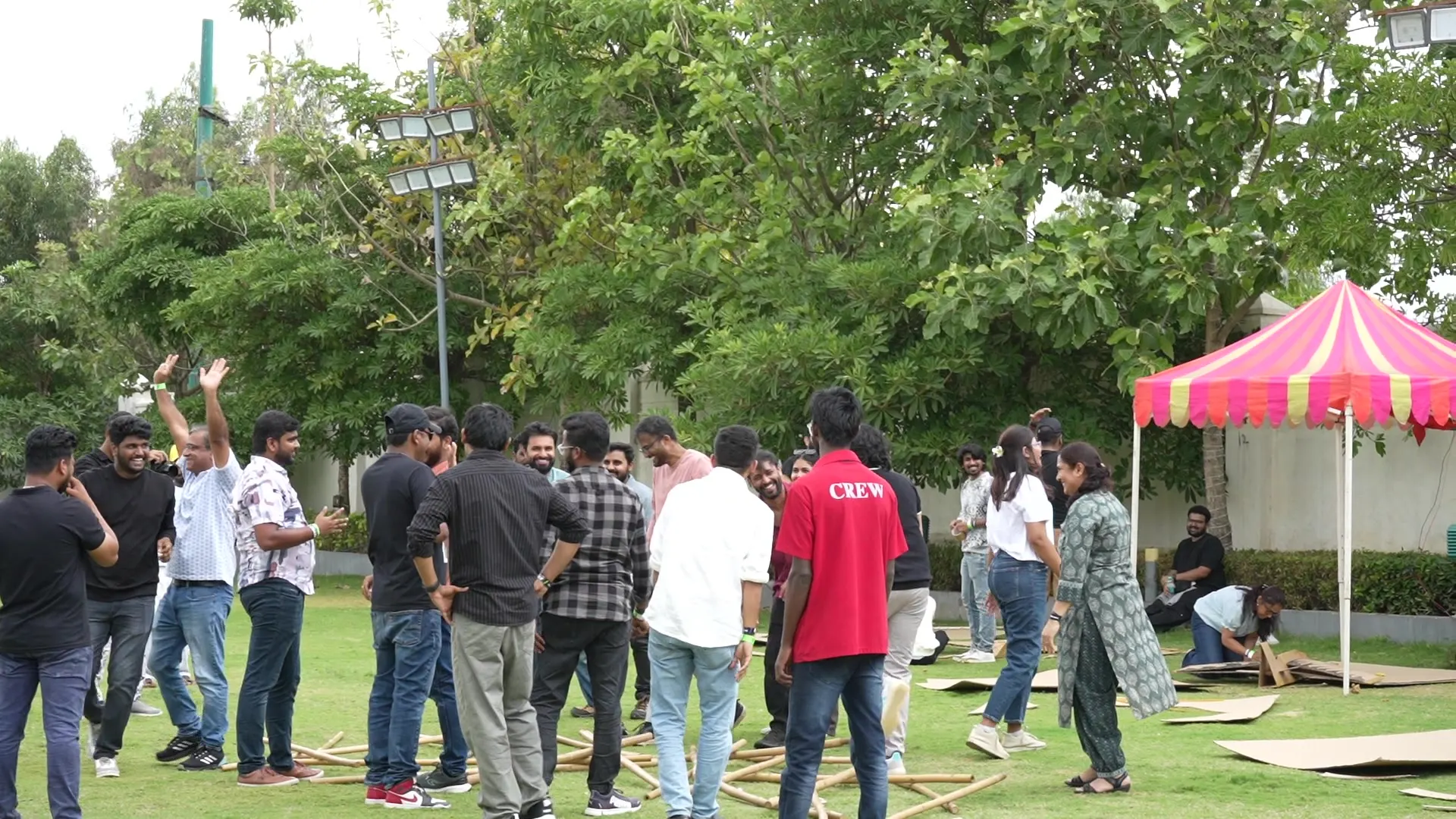 Team-building activity under tents on the lawn