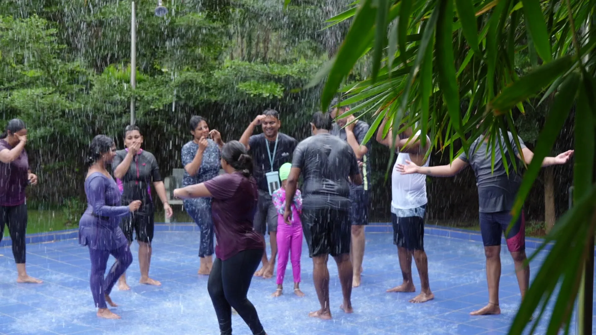 Group enjoying the rain dance at Sportico Resorts day outing