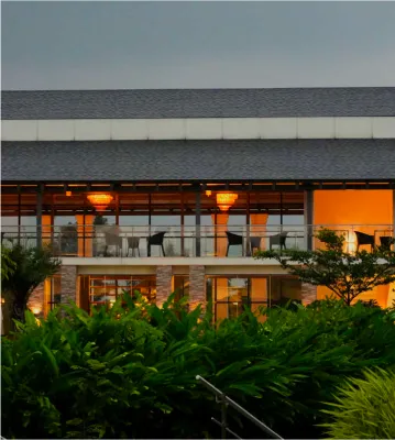 Resort building lit up in the evening at Sportico Resorts near Bangalore