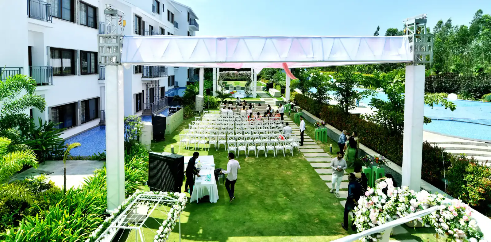 Wedding set-up on the lawn between the pool and villas at Sportico Resorts