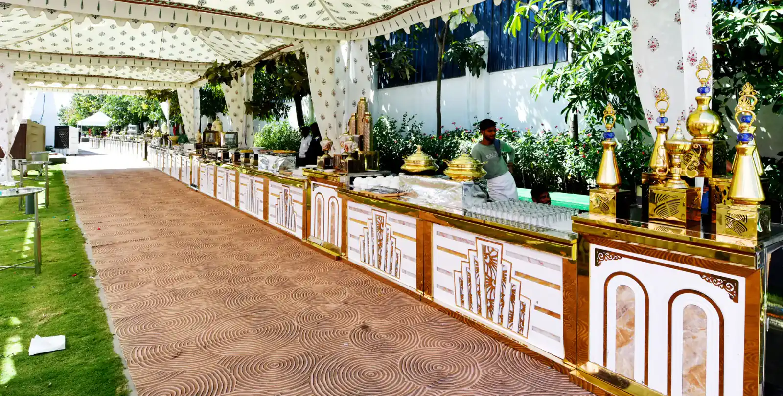 Buffet counters under a decorated tent at a Sportico wedding