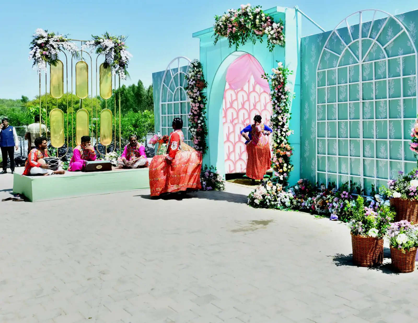 Pastel floral haldi set-up on the lawn at Sportico Resorts