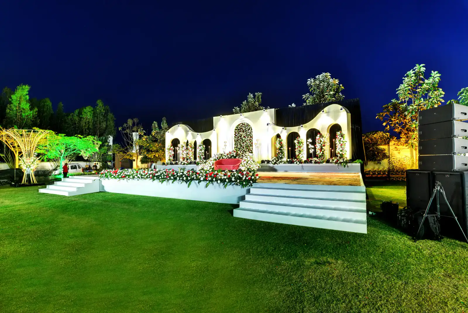 Side view of the wedding reception stage on the lawn at Sportico Resorts