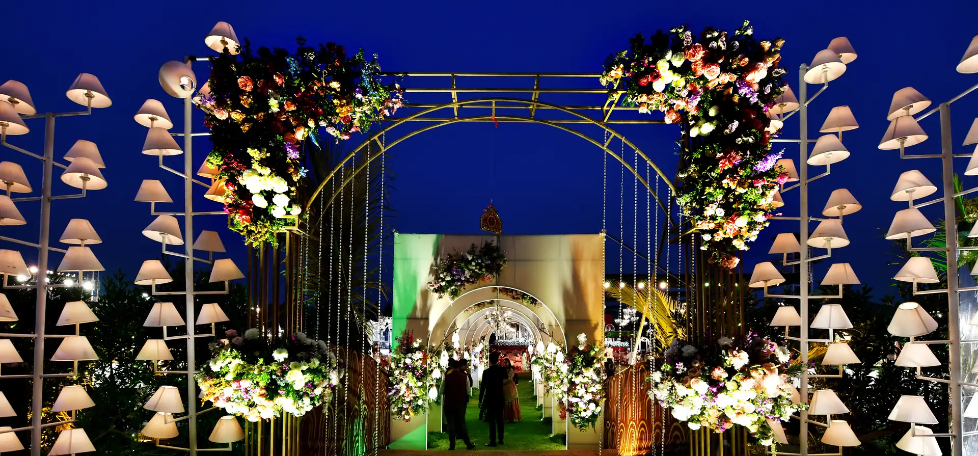 Wedding entrance lit with lamps at Sportico Resorts near Bangalore