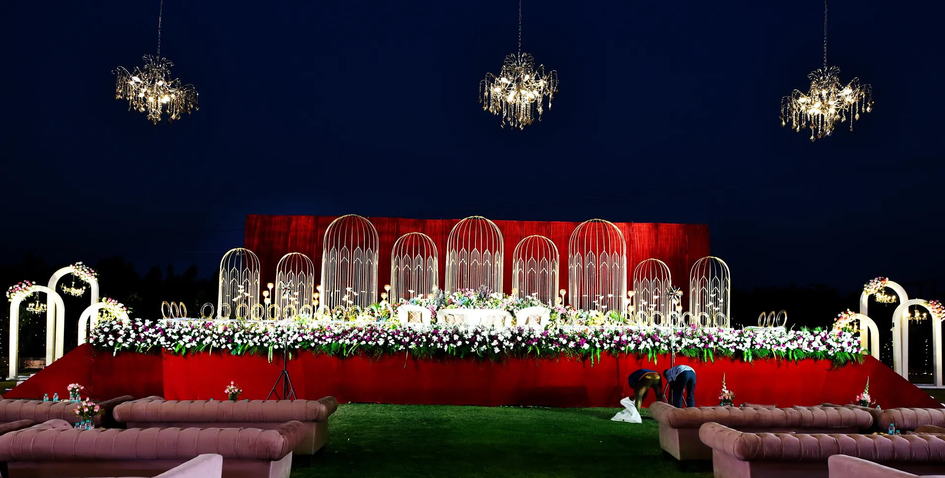 Red and gold wedding reception stage at Sportico Resorts